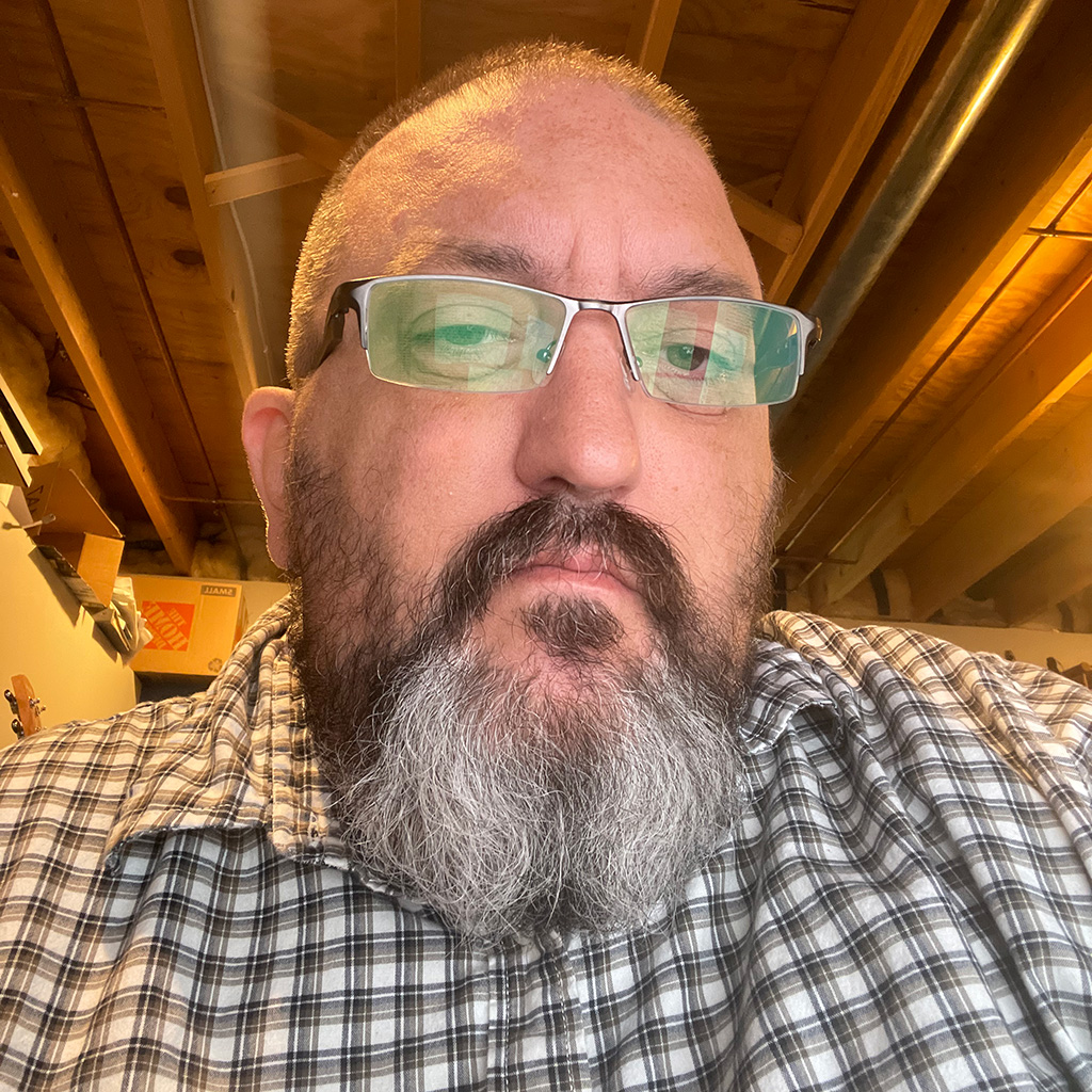 J Wynia — bearded man with glasses in a workshop